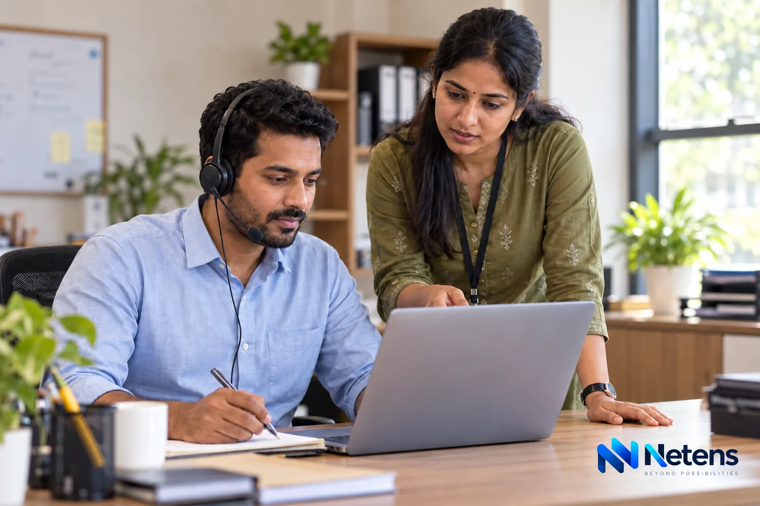 Indian customer support colleagues reviewing an enquiry and arranging a human follow-up