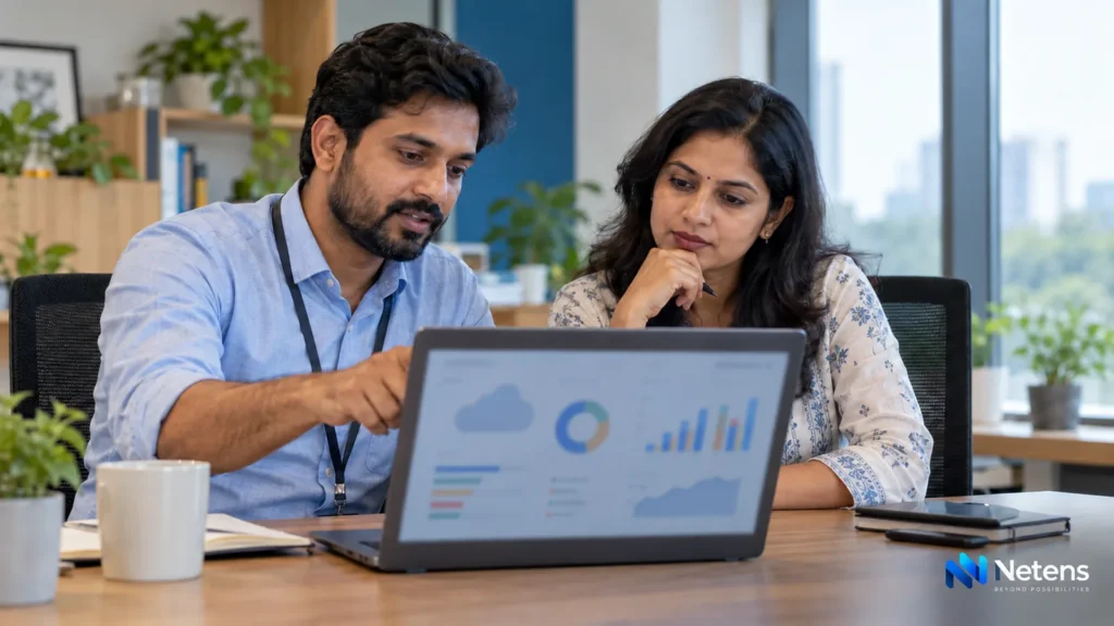Indian business owners reviewing cloud server costs on a laptop